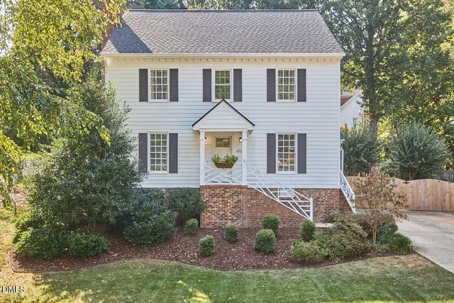 a aerial view of a house next to a yard