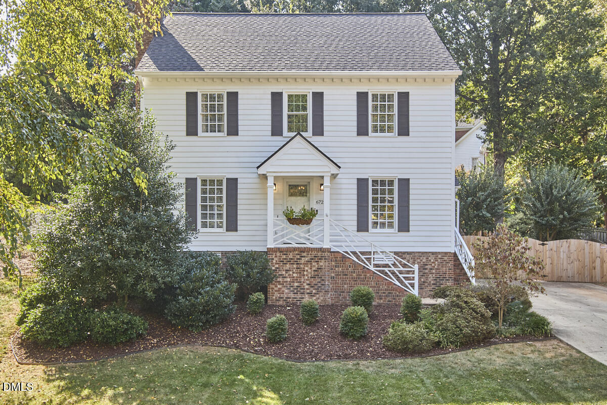a aerial view of a house next to a yard
