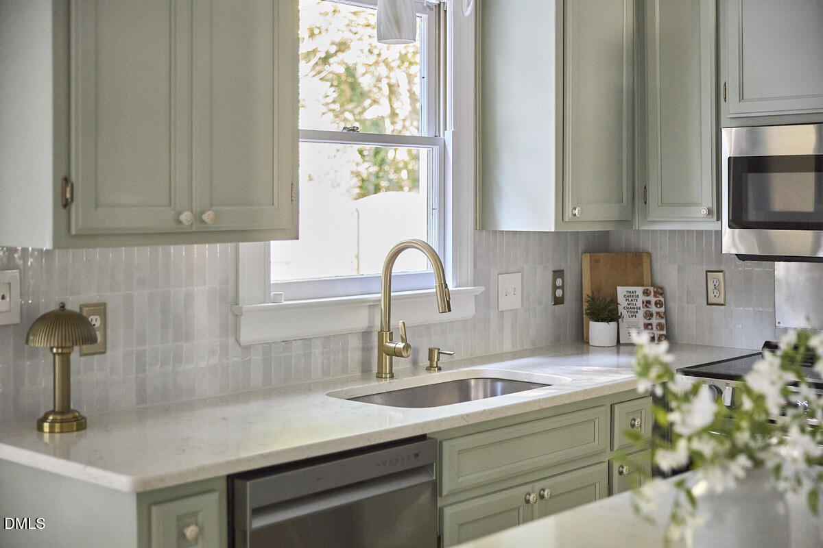 6725 Eastbrook Drive Raleigh, NC 27615 - Photo 13 of 48 a kitchen with a sink and a window