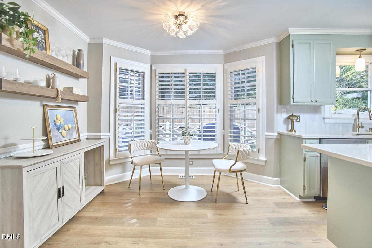 6725 Eastbrook Drive Raleigh, NC 27615 - Photo 17 of 48 a large white kitchen with a large window a sink and a counter space
