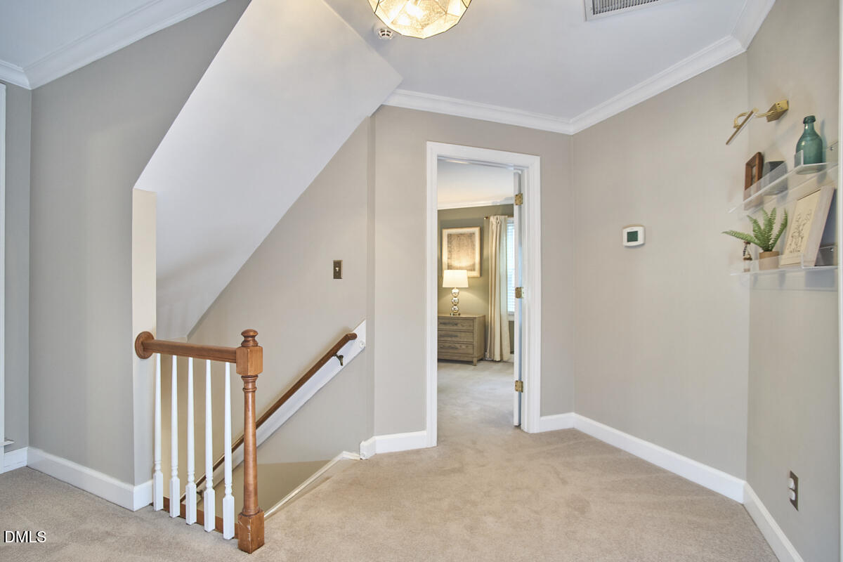 6725 Eastbrook Drive Raleigh, NC 27615 - Photo 24 of 48 a view of a hallway with staircase