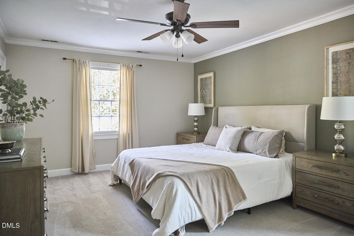 6725 Eastbrook Drive Raleigh, NC 27615 - Photo 26 of 48 a bedroom with a bed and a chandelier