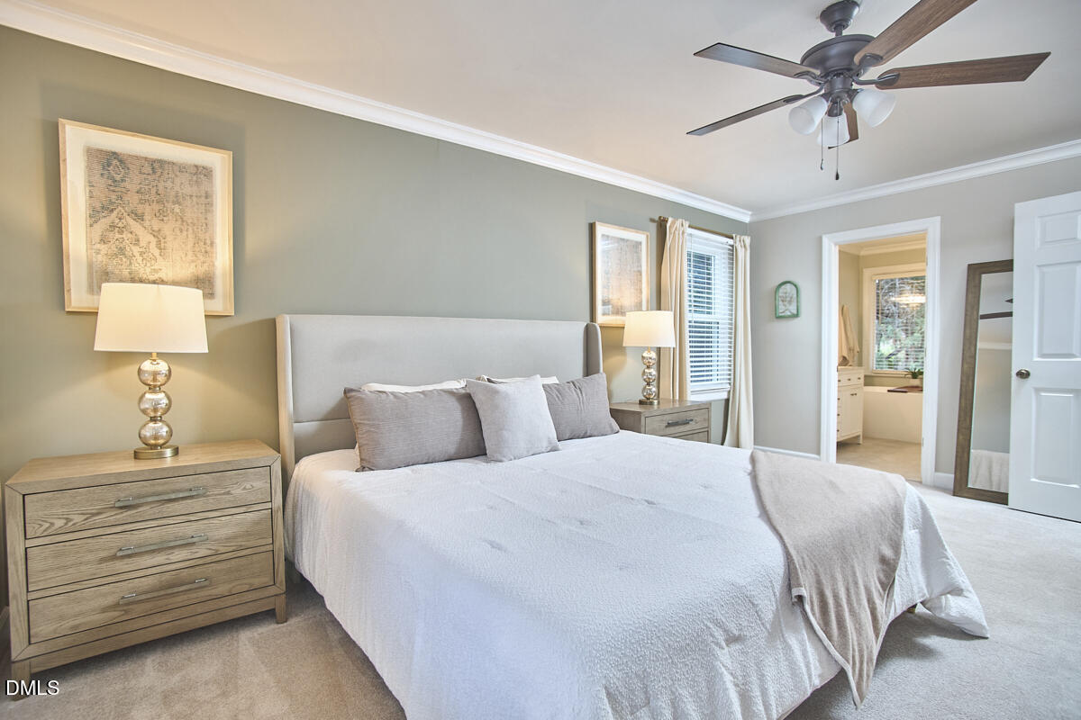 6725 Eastbrook Drive Raleigh, NC 27615 - Photo 27 of 48 a bedroom with a bed and a chandelier