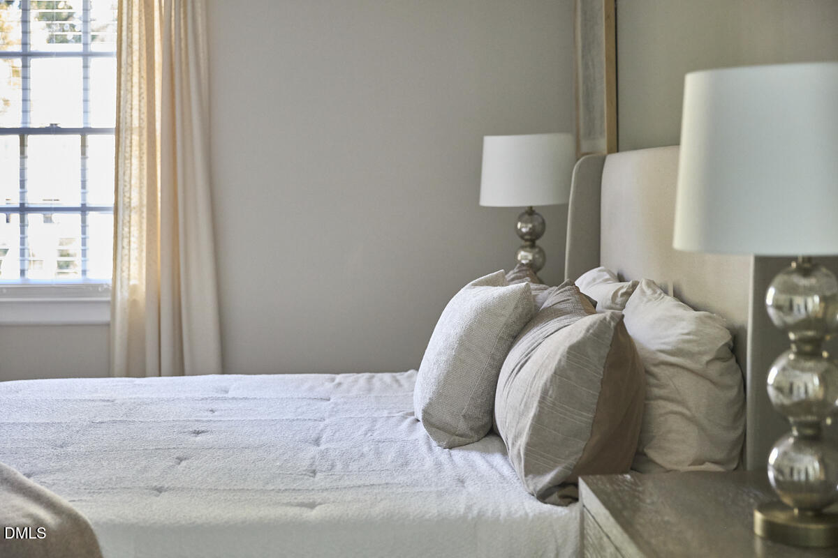 6725 Eastbrook Drive Raleigh, NC 27615 - Photo 28 of 48 a bedroom with a bed and a lamp