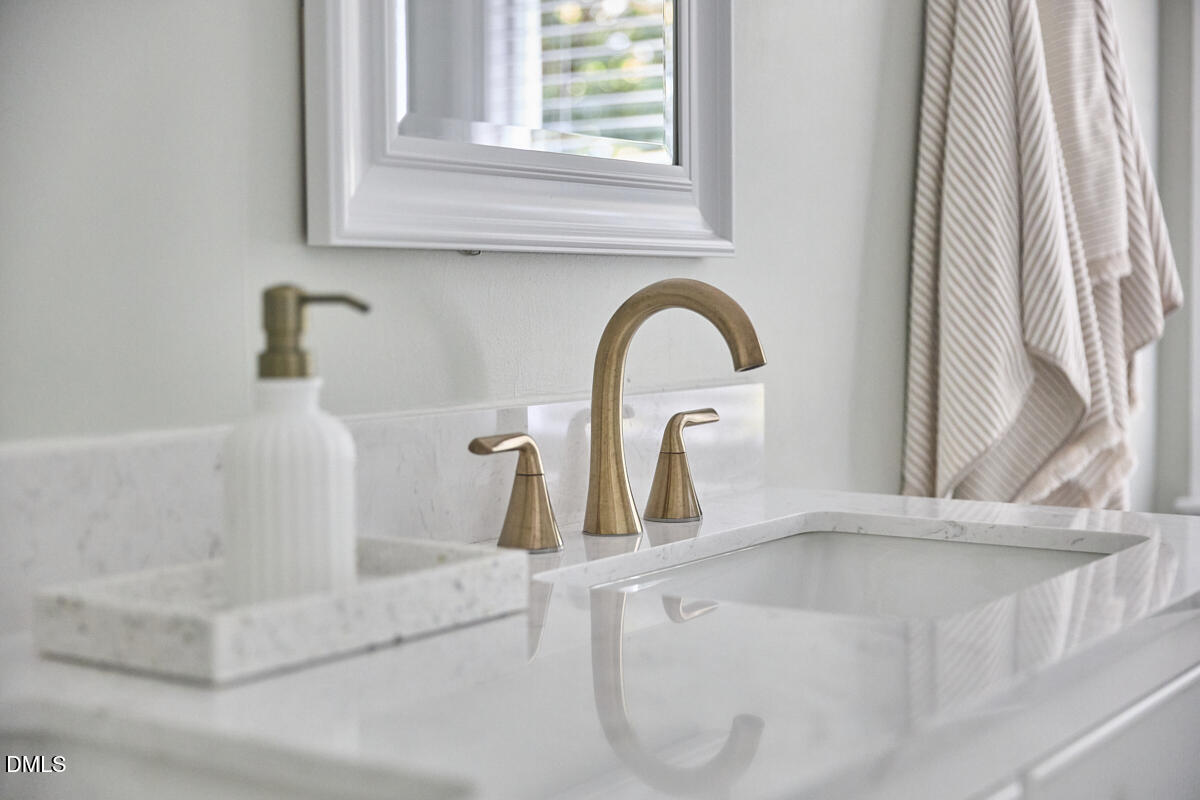 6725 Eastbrook Drive Raleigh, NC 27615 - Photo 34 of 48 a close view of a faucet a sink and a window