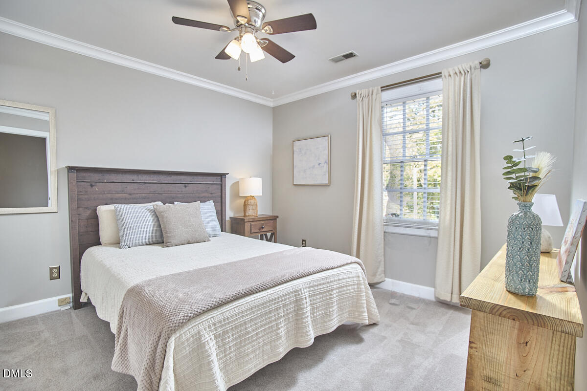 6725 Eastbrook Drive Raleigh, NC 27615 - Photo 37 of 48 a bedroom with a bed and a window