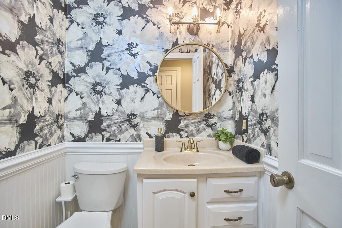 6725 Eastbrook Drive Raleigh, NC 27615 - Photo 39 of 48 a bathroom with a sink and mirror with toilet