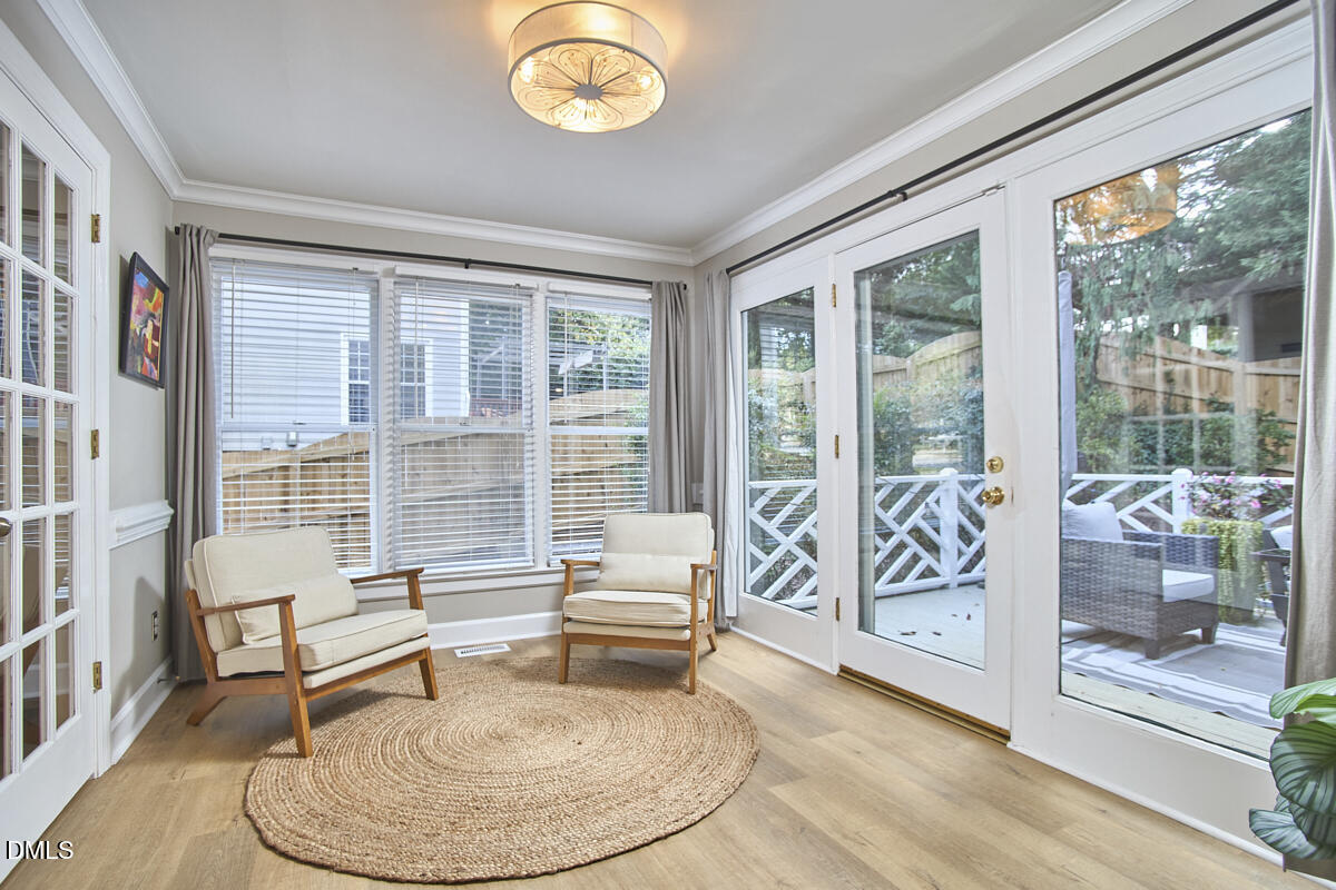 6725 Eastbrook Drive Raleigh, NC 27615 - Photo 41 of 48 a living room with furniture and a floor to ceiling window