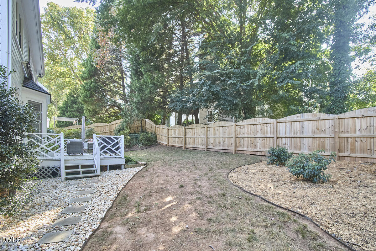 6725 Eastbrook Drive Raleigh, NC 27615 - Photo 47 of 48 a view of a backyard with a table and chairs