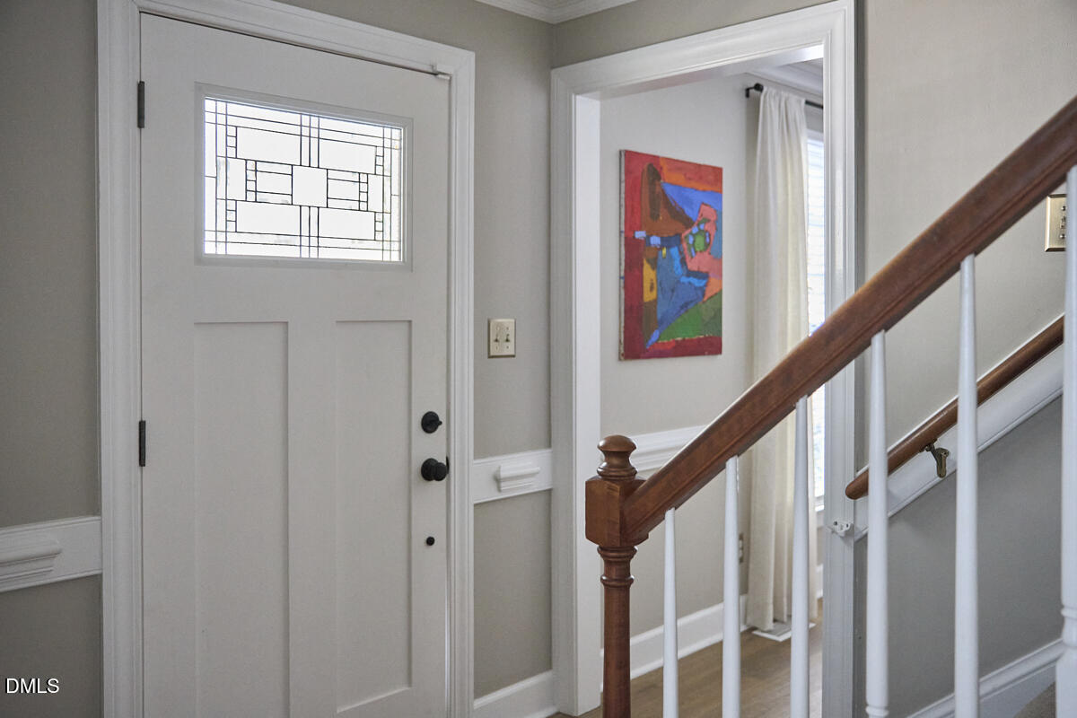 6725 Eastbrook Drive Raleigh, NC 27615 - Photo 5 of 48 a view of an entryway with wooden floor and paintings on the walls