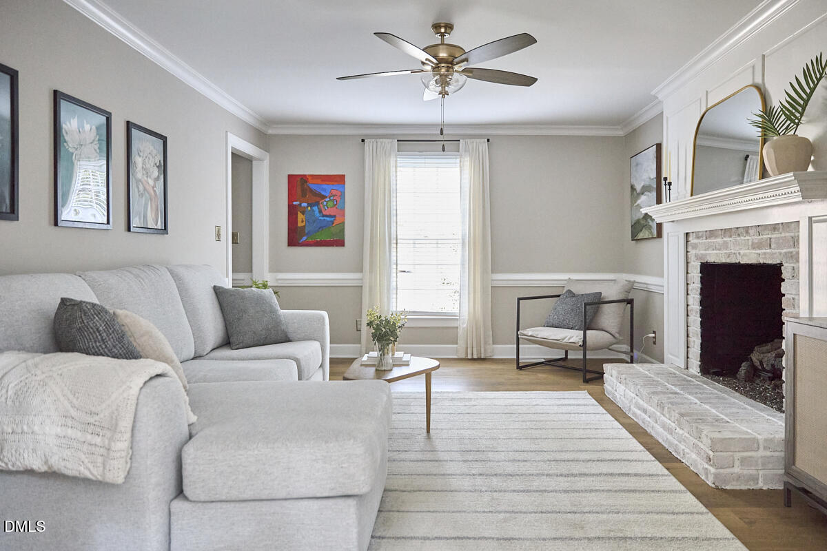 6725 Eastbrook Drive Raleigh, NC 27615 - Photo 6 of 48 a living room with furniture and a fireplace