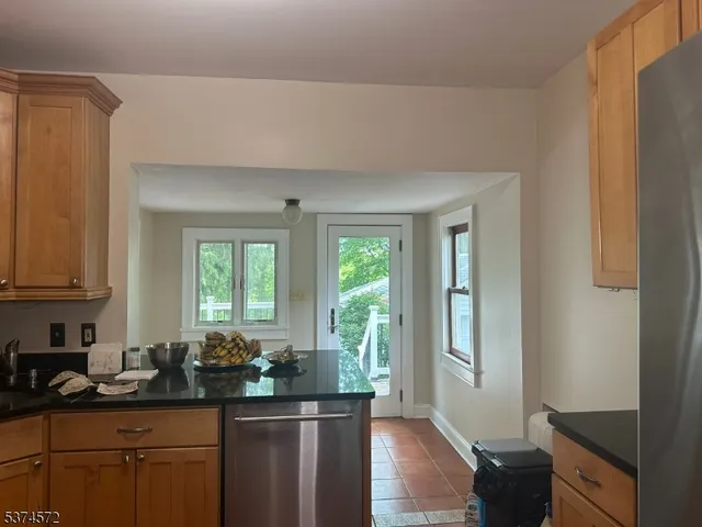 a kitchen with stainless steel appliances a sink stove and cabinets