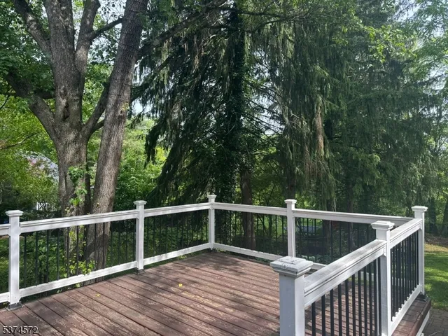 a view of a wooden deck and trees