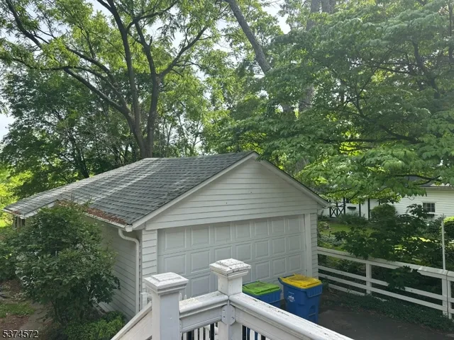 a view of a small house and yard from a balcony