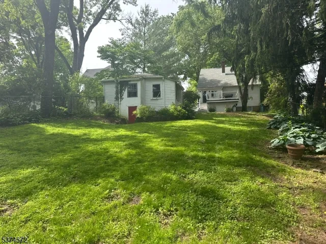 a view of a house with a backyard