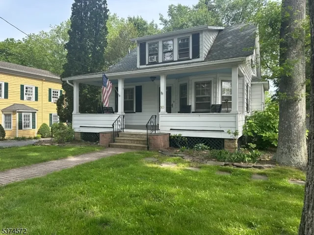 a view of a house with a yard and sitting area