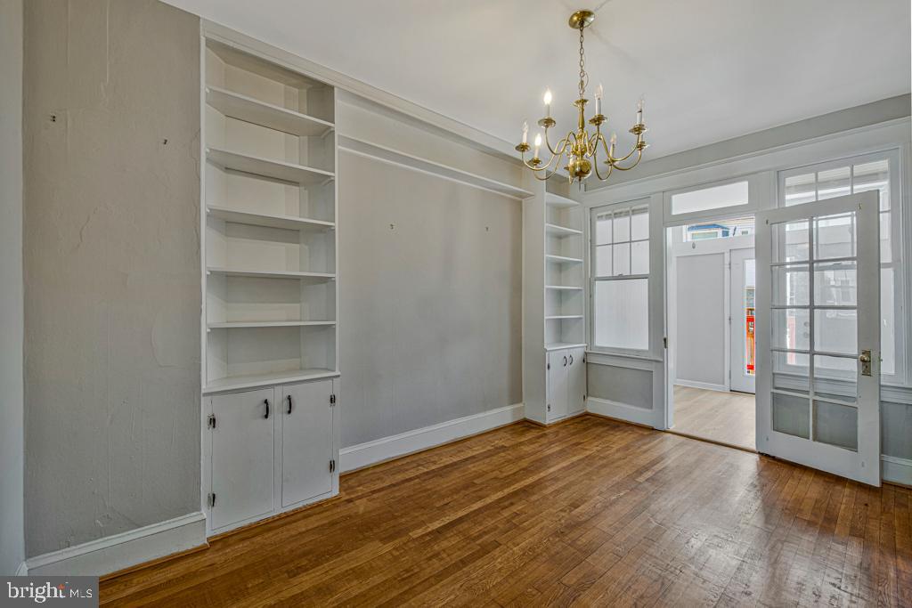 2406 37th Street Northwest Washington, DC 20007 - Photo 24 of 44 a view of an empty room with a window and wooden floor