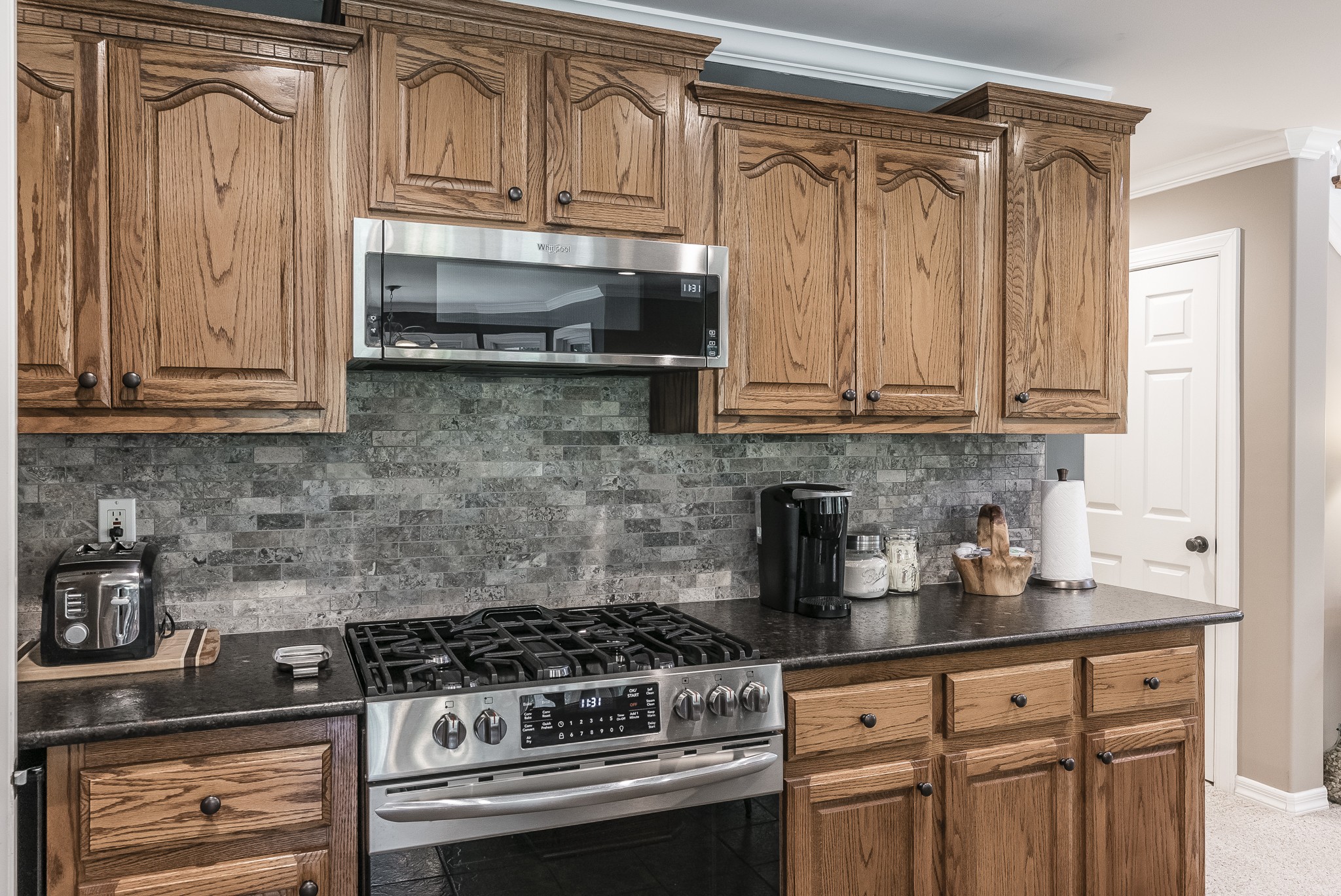 443 Mt Vernon Road Bethpage, TN 37022 - Photo 11 of 40 a kitchen with granite countertop a stove a microwave and cabinets