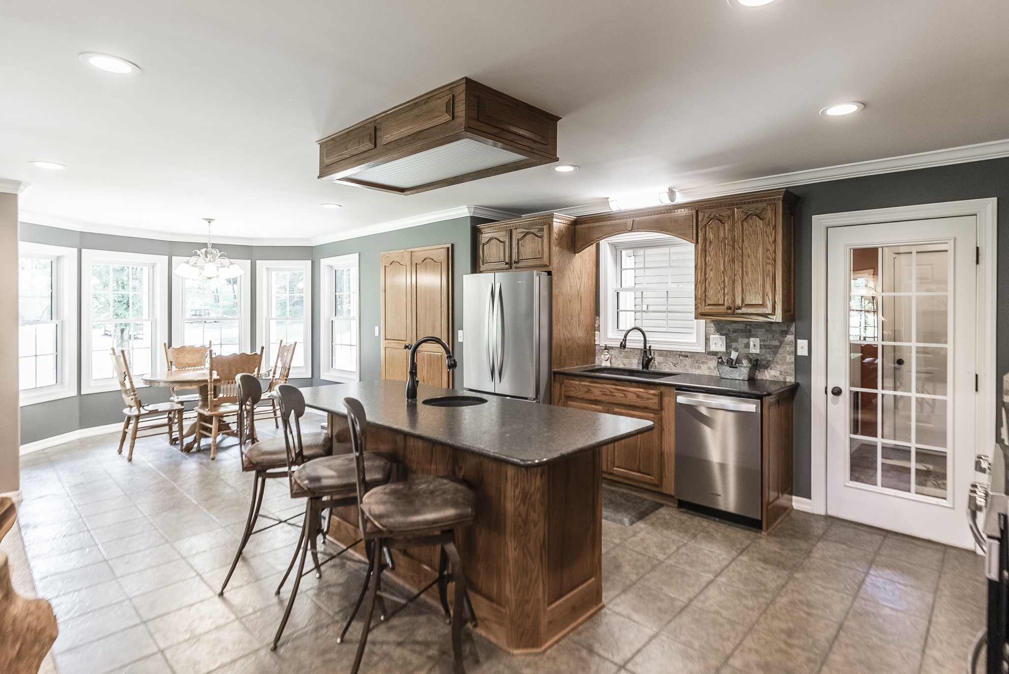 443 Mt Vernon Road Bethpage, TN 37022 - Photo 12 of 40 a kitchen with stainless steel appliances granite countertop table chairs and a large window