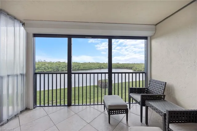 a bedroom with a bed flat screen tv and a window
