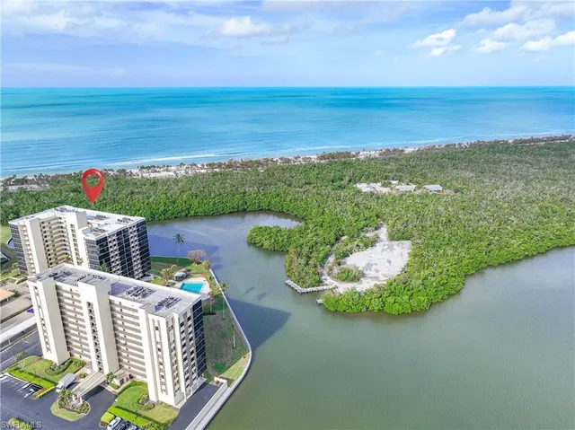 a view of a lake with a multi story building and a big yard