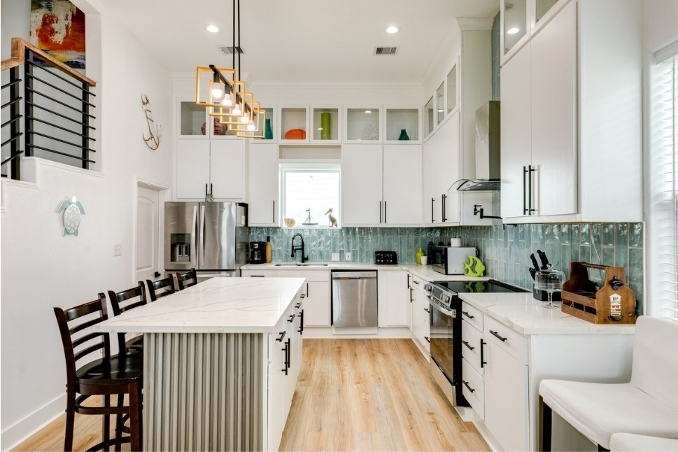 23327 Termini-San Luis Pass Road Galveston, TX 77554 - Photo 11 of 39 a kitchen that has a lot of cabinets in it and appliances