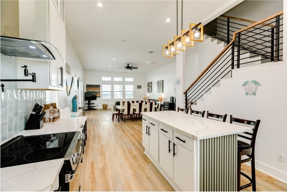 23327 Termini-San Luis Pass Road Galveston, TX 77554 - Photo 12 of 39 a kitchen with a sink a stove and chairs