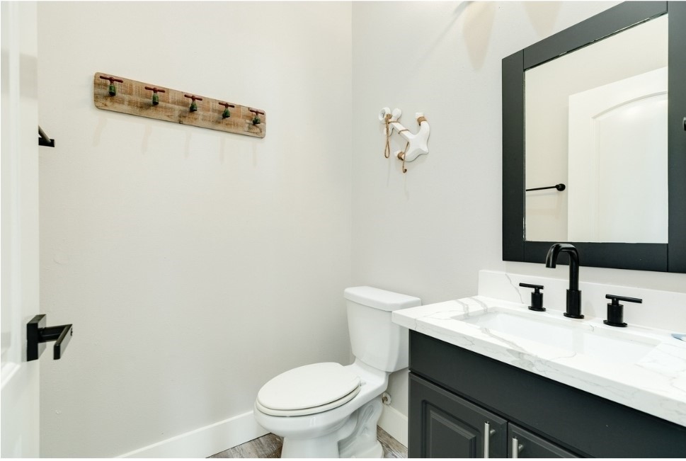 23327 Termini-San Luis Pass Road Galveston, TX 77554 - Photo 27 of 39 a bathroom with a sink a toilet and mirror