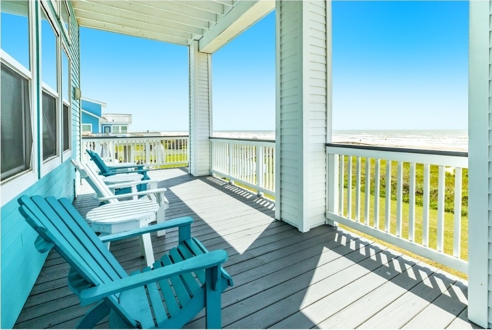23327 Termini-San Luis Pass Road Galveston, TX 77554 - Photo 29 of 39 a balcony with wooden floor table and chairs