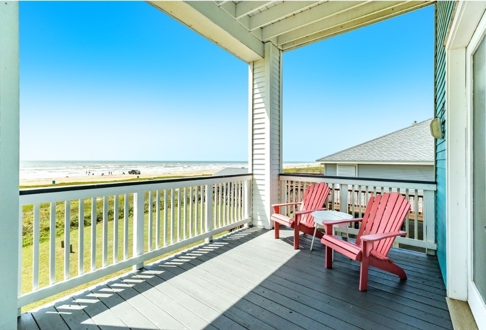 23327 Termini-San Luis Pass Road Galveston, TX 77554 - Photo 31 of 39 a balcony with wooden floor table and chairs