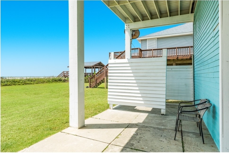 23327 Termini-San Luis Pass Road Galveston, TX 77554 - Photo 33 of 39 a backyard of a house with a table and chairs