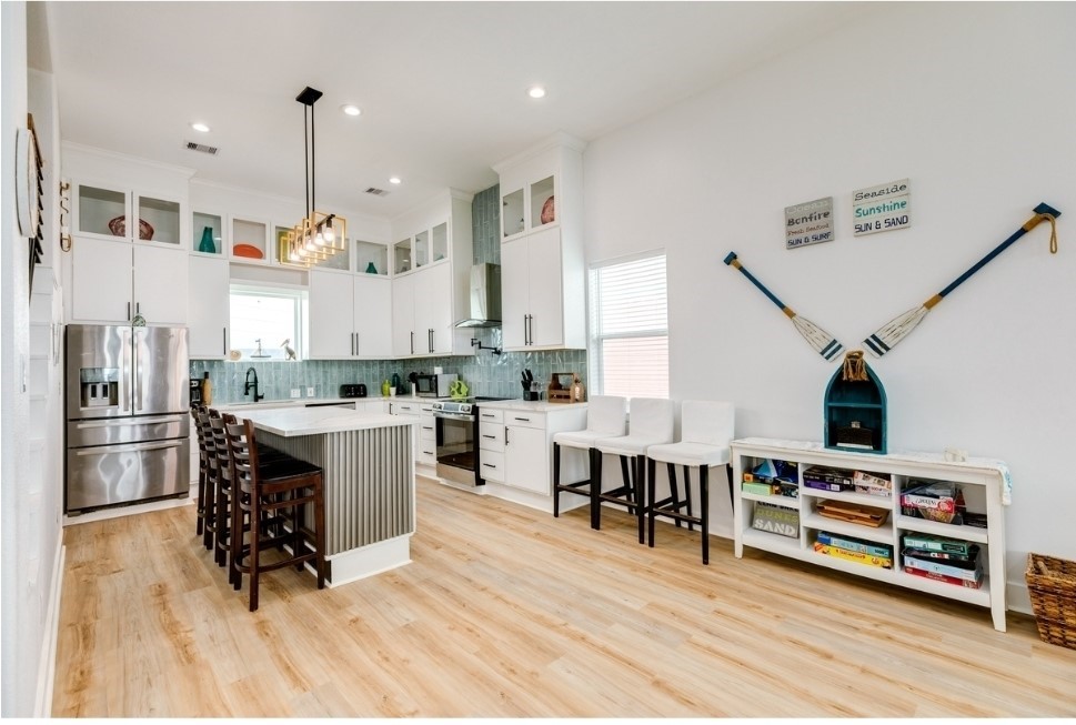 23327 Termini-San Luis Pass Road Galveston, TX 77554 - Photo 9 of 39 a kitchen with stainless steel appliances granite countertop a refrigerator a stove and a wooden floors