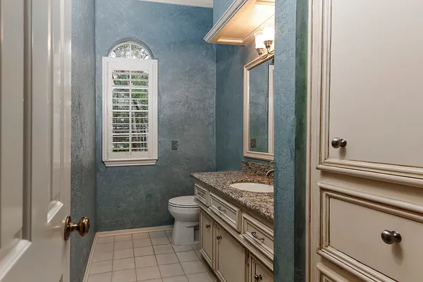 a kitchen with kitchen island granite countertop a sink and a stove
