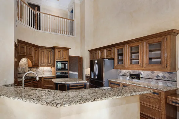 a kitchen with stainless steel appliances granite countertop a stove and a refrigerator