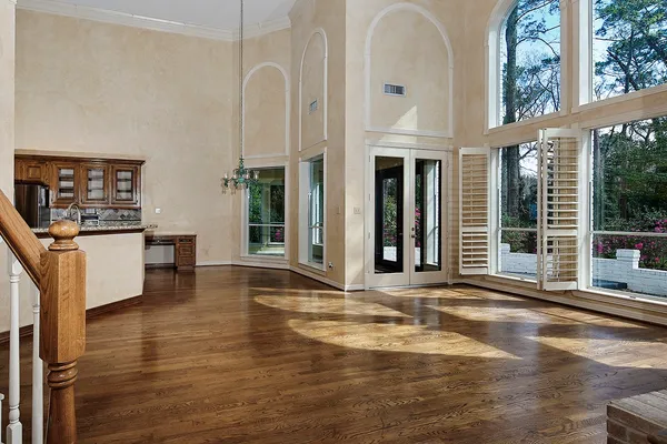 a open kitchen with stainless steel appliances kitchen island granite countertop a refrigerator a stove a sink and dishwasher with wooden floor