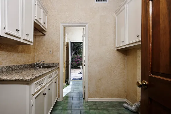 a bathroom with a granite countertop sink a mirror and a shower