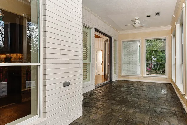 a large white kitchen with a large window a sink and stainless steel appliances