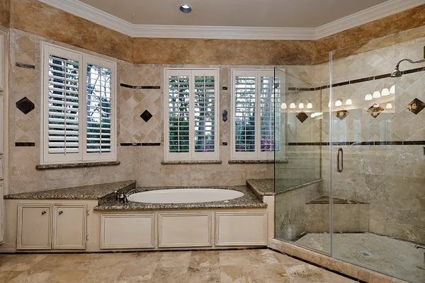 a spacious bathroom with a granite countertop sink mirror and a