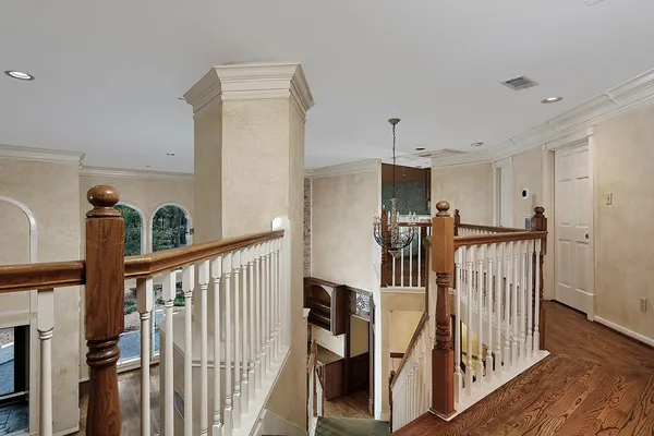 a front view of a house with a yard and fountain