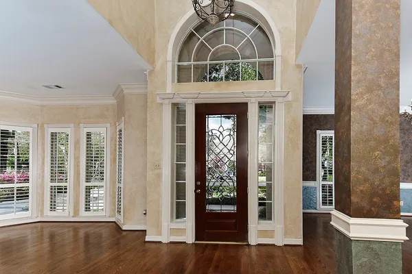 a view of an entryway with wooden floor and a livingroom