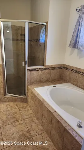 a bathroom with a bathtub and shower