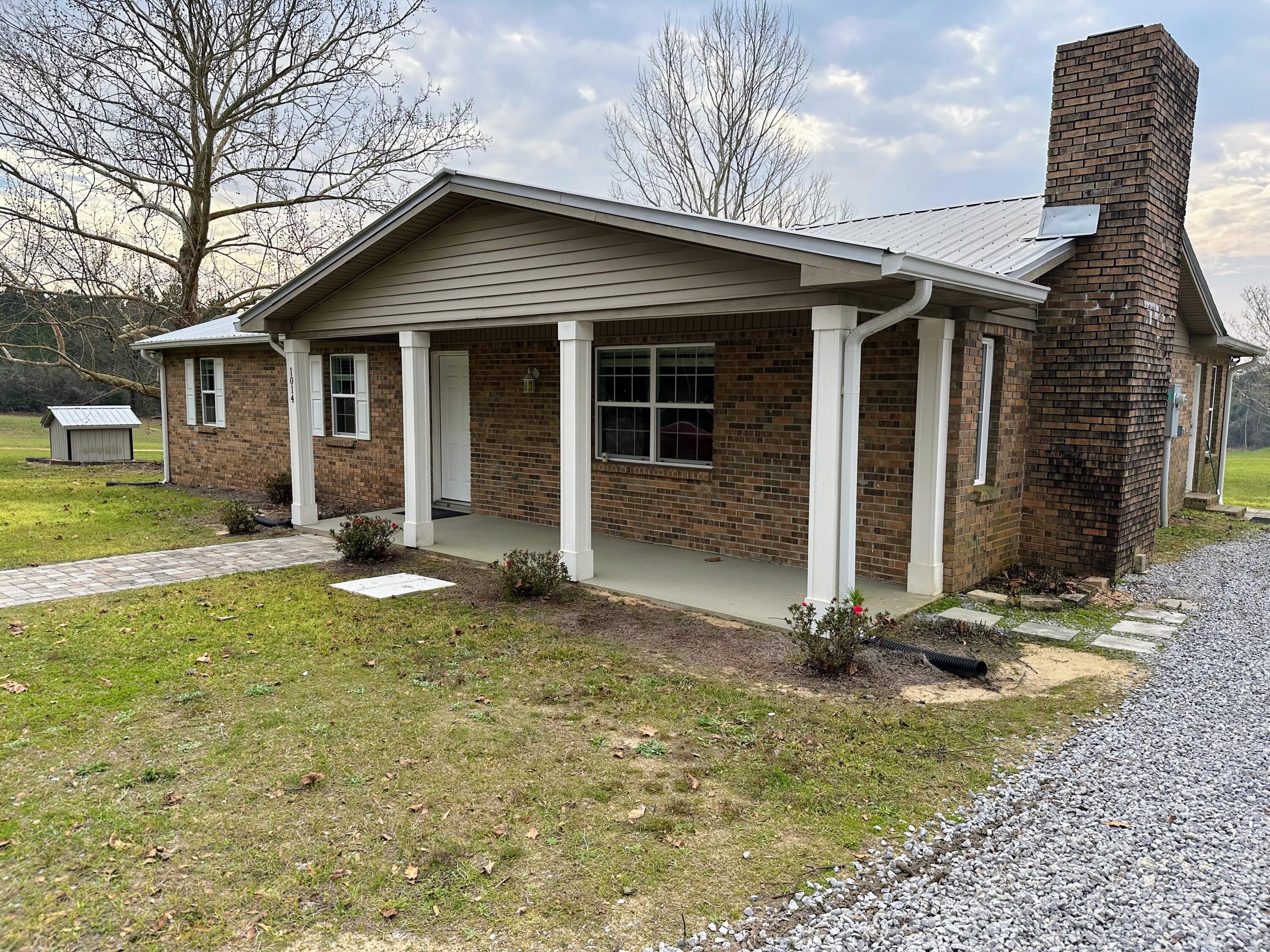 1014 East Indian Creek Ranch Road DeFuniak Springs, FL 32435 - Photo 16 of 17 a front view of a house with garden