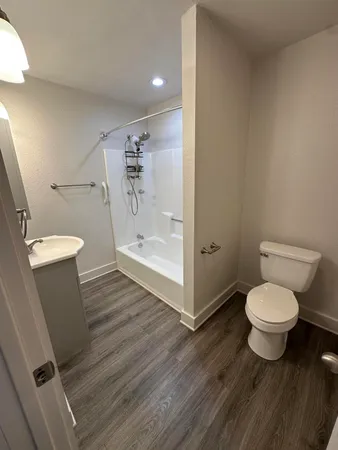 a bathroom with a toilet and a shower