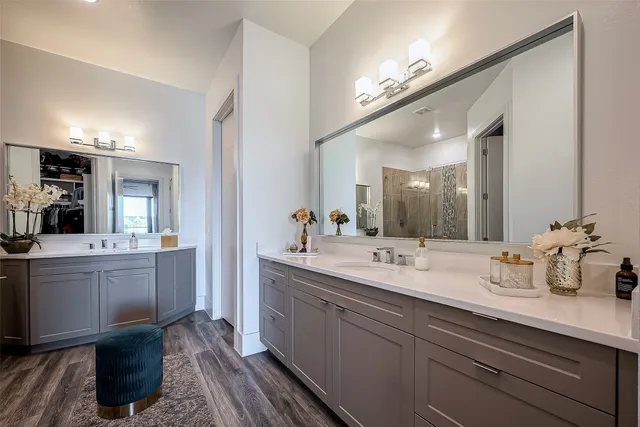 a bathroom with double vanity sinks a vanity and a mirror