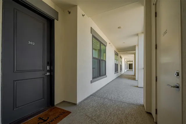a view of a hallway with wooden shelves