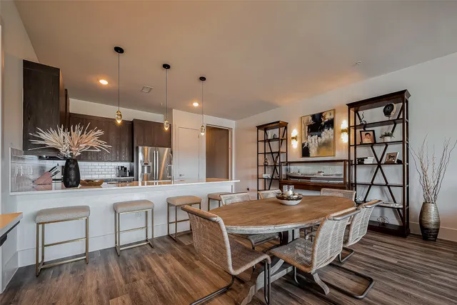 a dining room with furniture and wooden floor