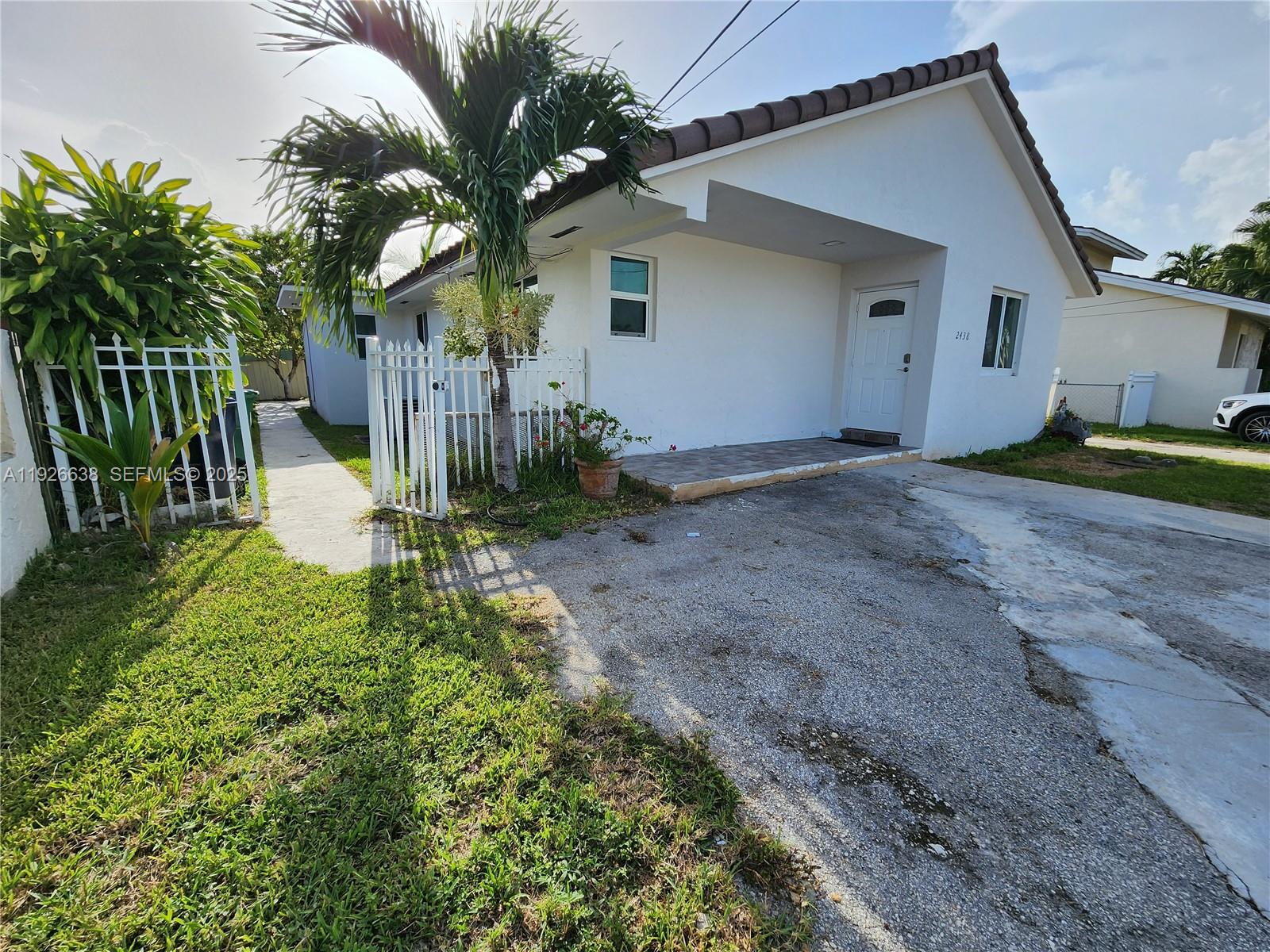 2438 Southwest 114th Avenue Miami, FL 33165 - Photo 1 of 15 a view of a house with a yard and plants