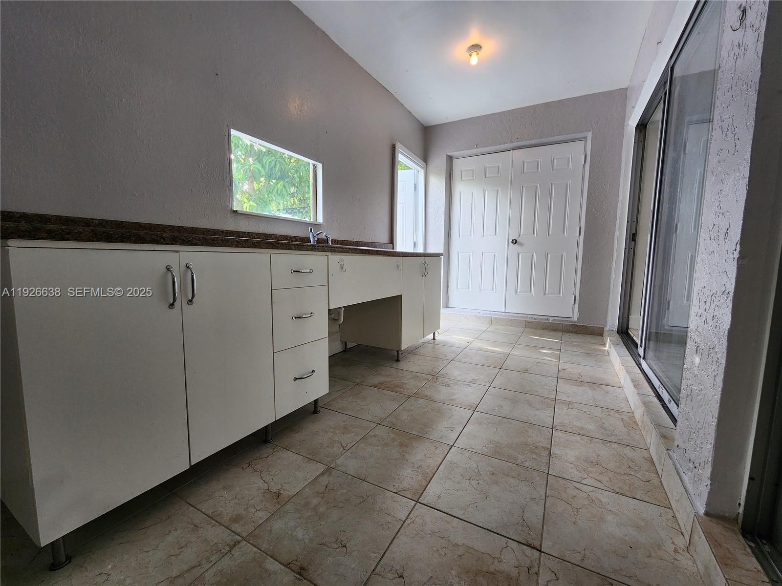 2438 Southwest 114th Avenue Miami, FL 33165 - Photo 11 of 15 a view of an empty room with a window