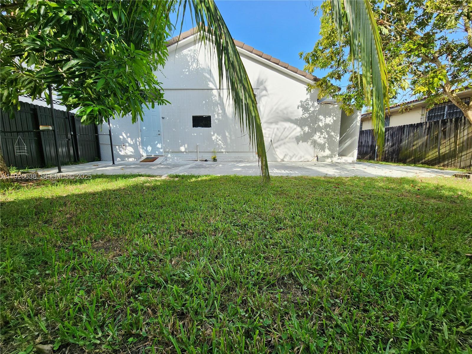 2438 Southwest 114th Avenue Miami, FL 33165 - Photo 14 of 15 a view of backyard with table and chairs and potted plants