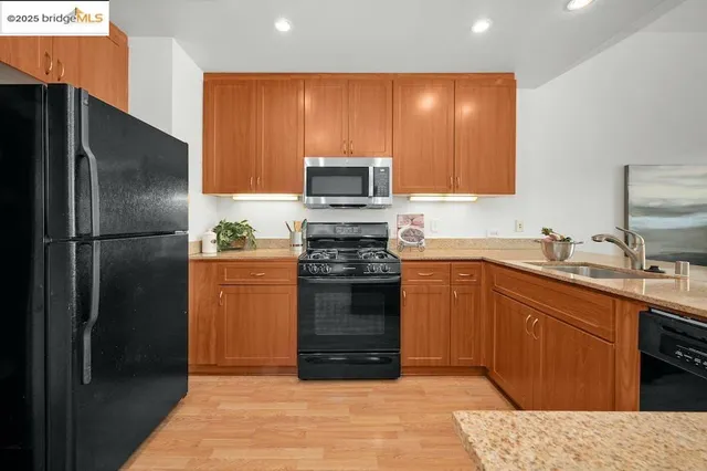 a kitchen with a sink stove and cabinets